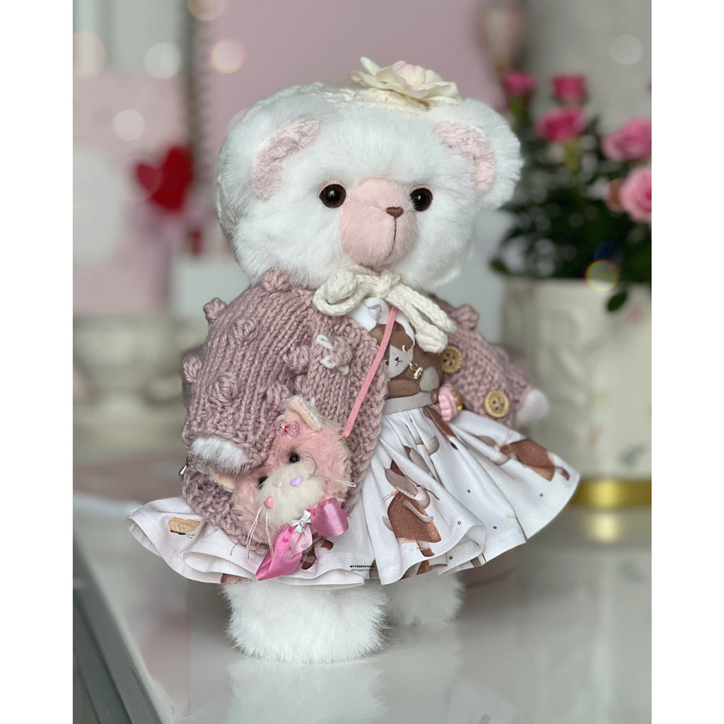 Teddy bear in a dress with cats