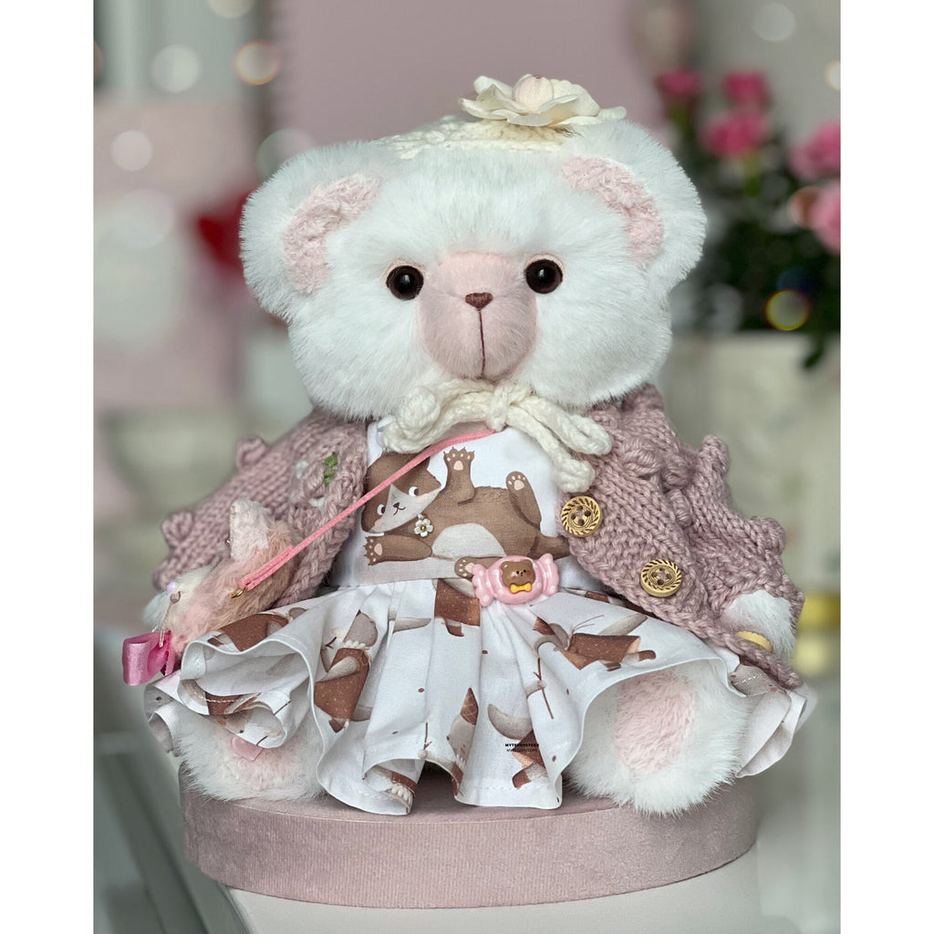 Teddy bear in a dress with cats