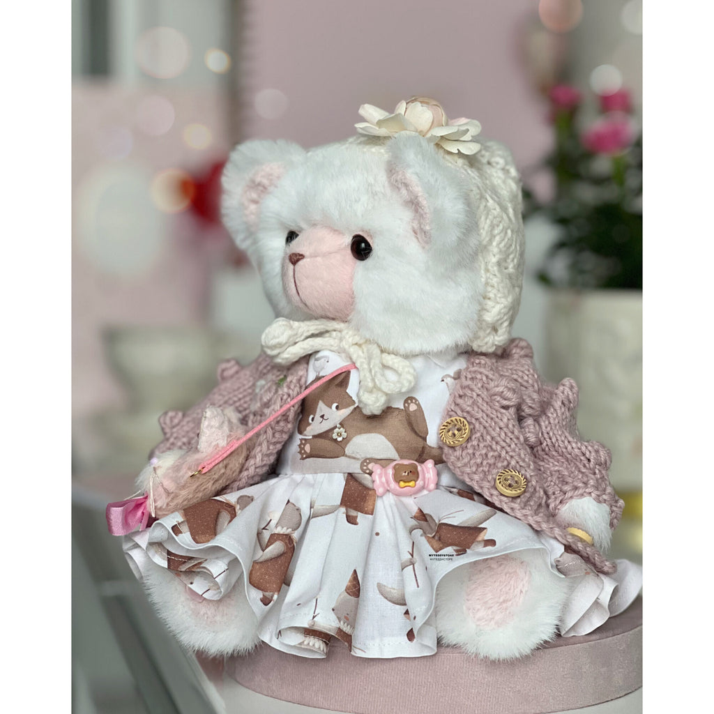 Teddy bear in a dress with cats