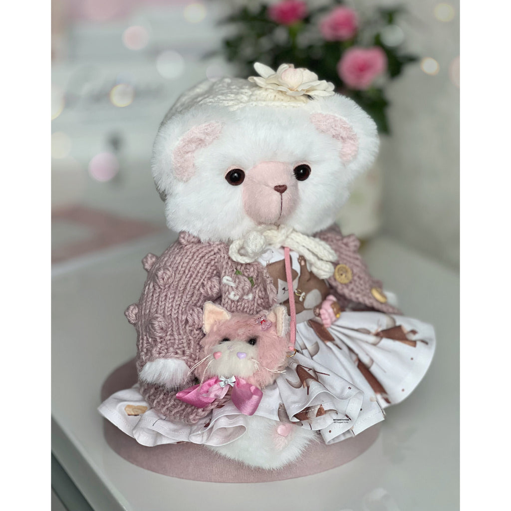 Teddy bear in a dress with cats