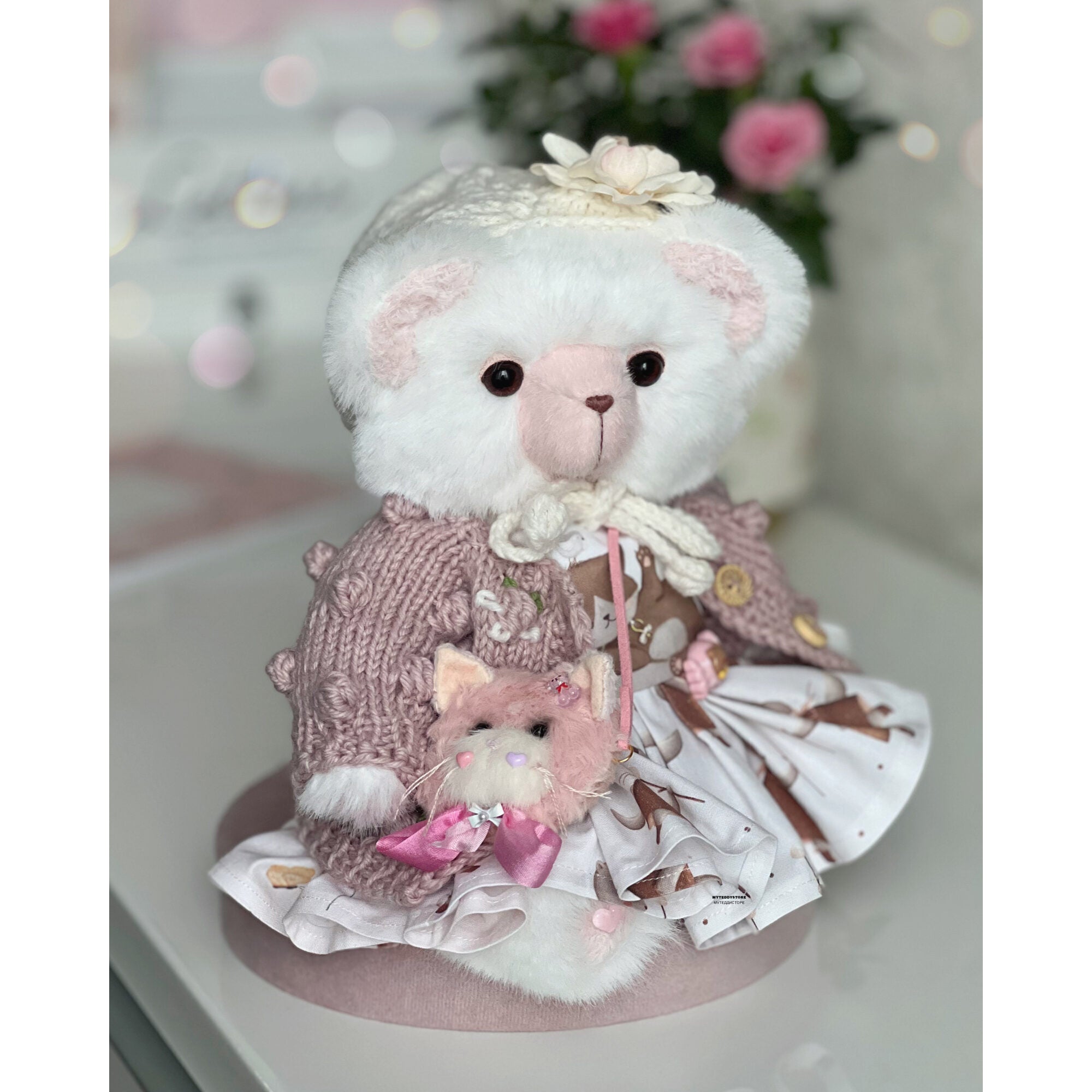 Teddy bear in a dress with cats
