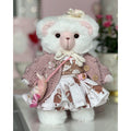 Teddy bear in a dress with cats